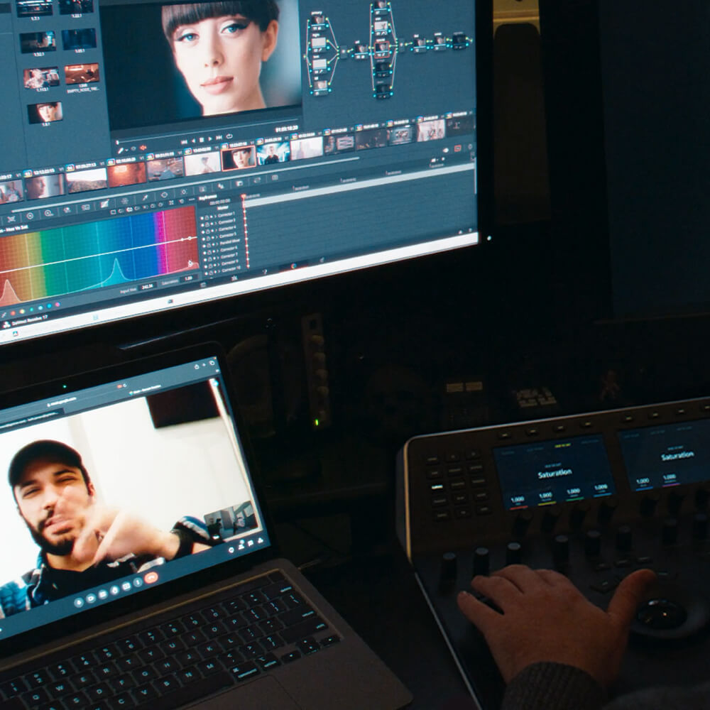Colorist in suite with client on remote screen